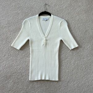 3/4 sleeve, three button henley.  Generous XS lots of stretch.  Michael Stars